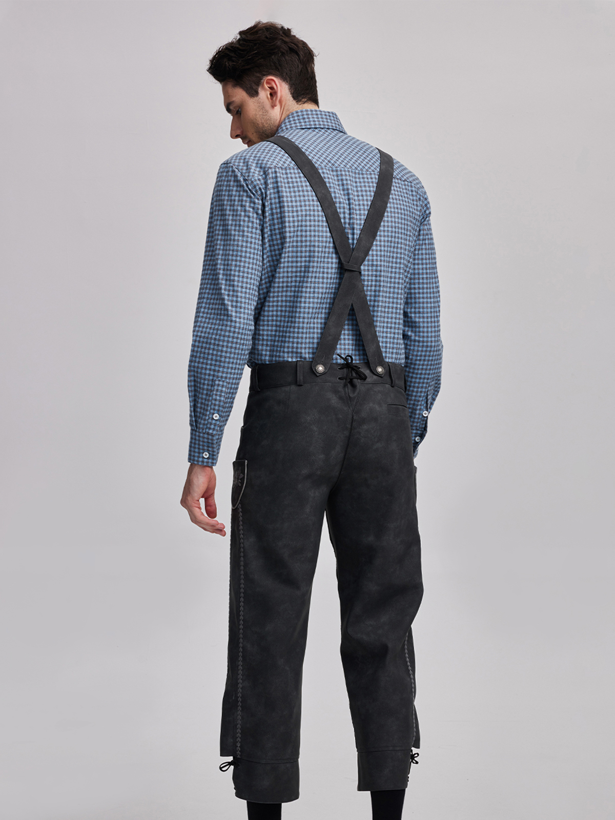 Ein graues Dirndl mit traditioneller Schürze und passender Bluse